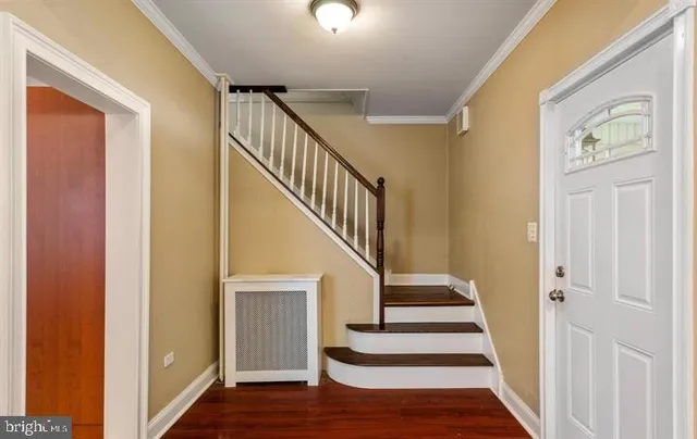 a view of entryway and hall with wooden floor