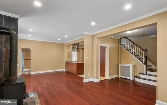 a view of hallway with wooden floor and stairs