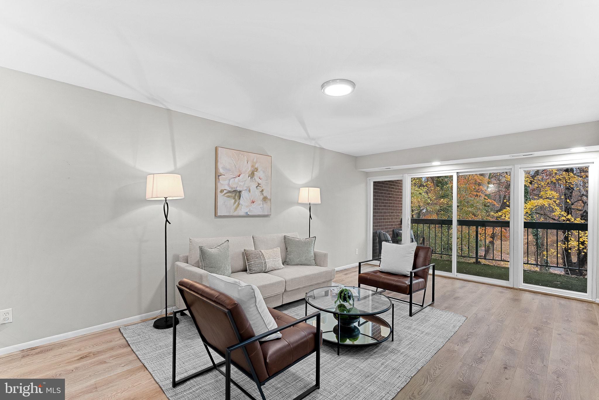 11808 Breton Court, Unit 12C Reston, VA 20191 - Photo 3 of 28 Formal Living Room w/ wooded views