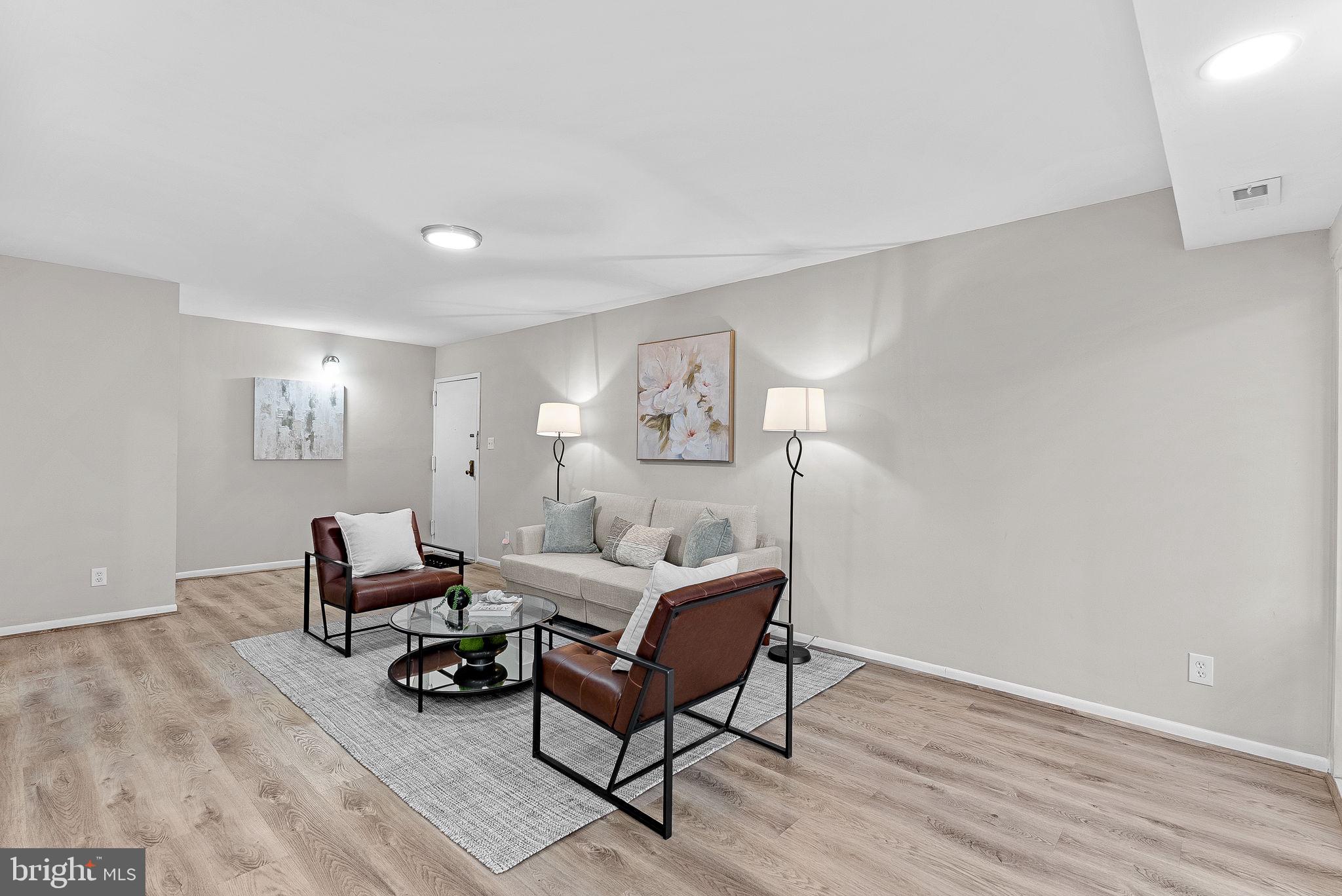 11808 Breton Court, Unit 12C Reston, VA 20191 - Photo 4 of 28 Formal Living Room w/ wooded views