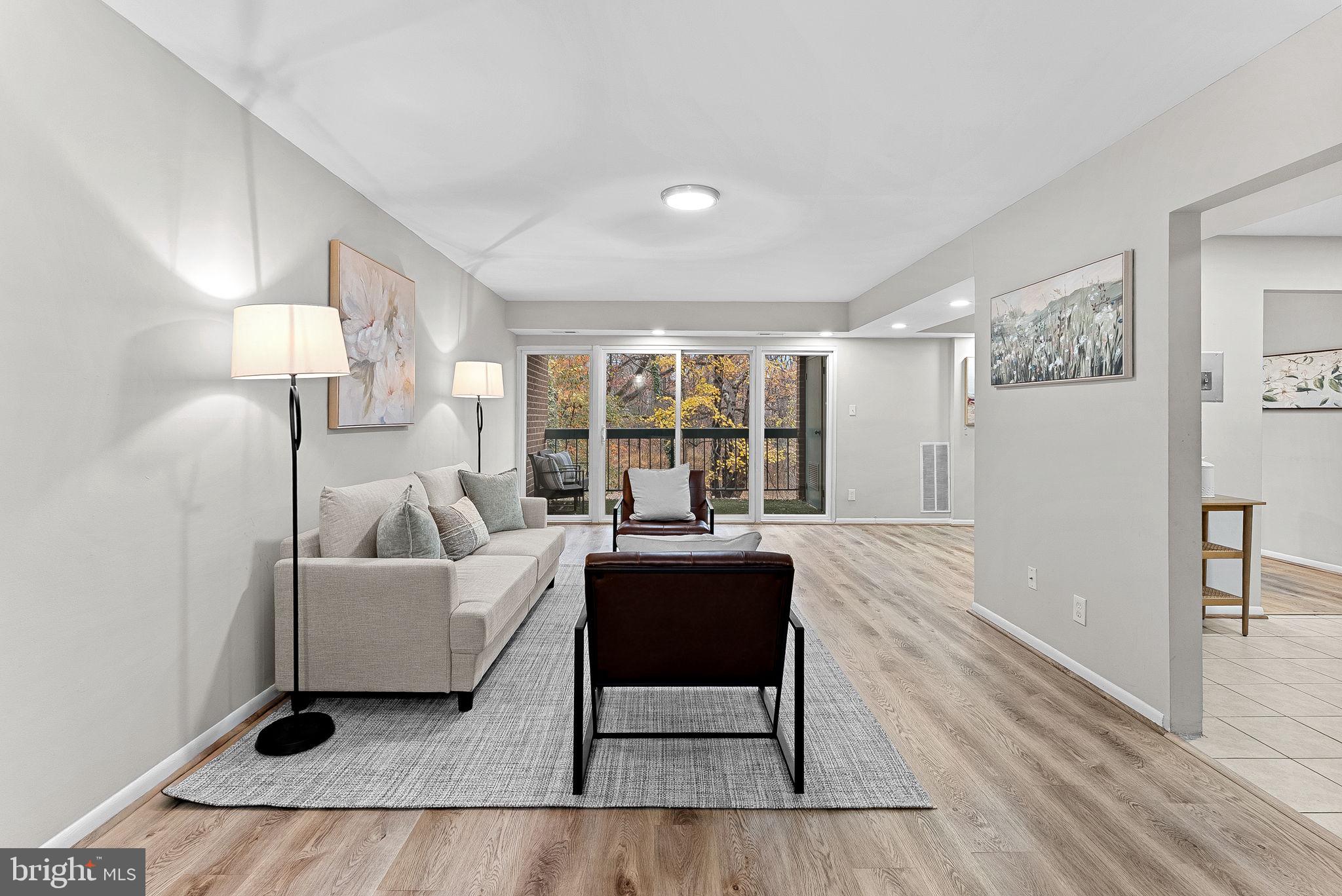 11808 Breton Court, Unit 12C Reston, VA 20191 - Photo 5 of 28 Formal Living Room w/ wooded views