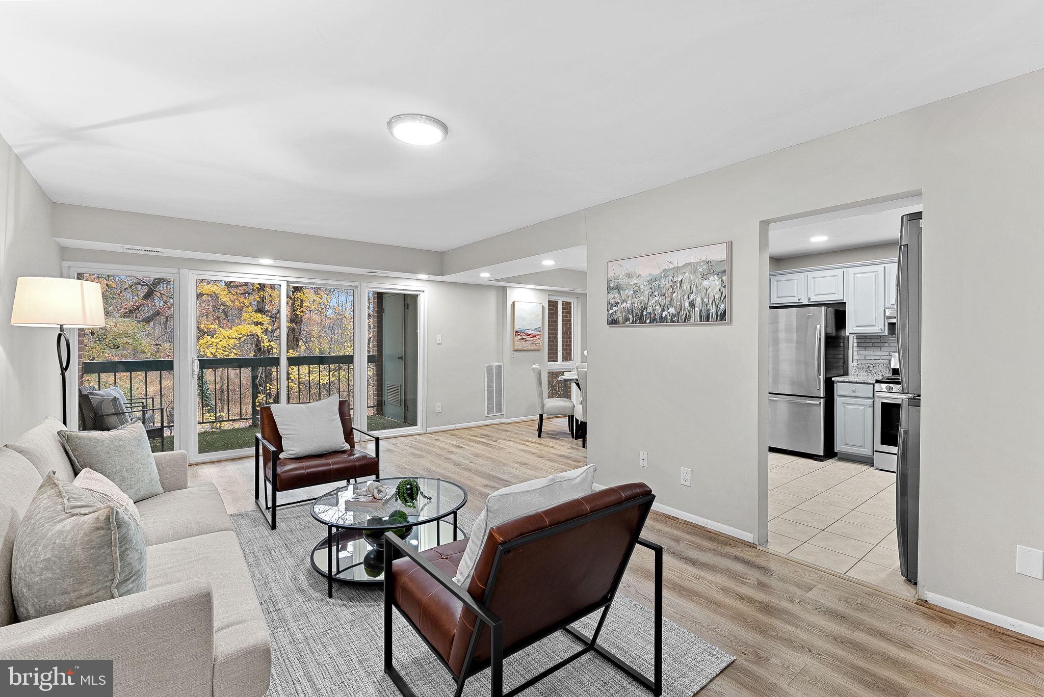 11808 Breton Court, Unit 12C Reston, VA 20191 - Photo 6 of 28 Formal Living Room w/ wooded views