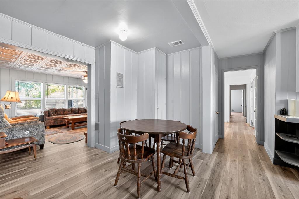 5485 Highway 7 Marlin, TX 76661 - Photo 10 of 36 Dining area with light wood-type flooring and wooden walls