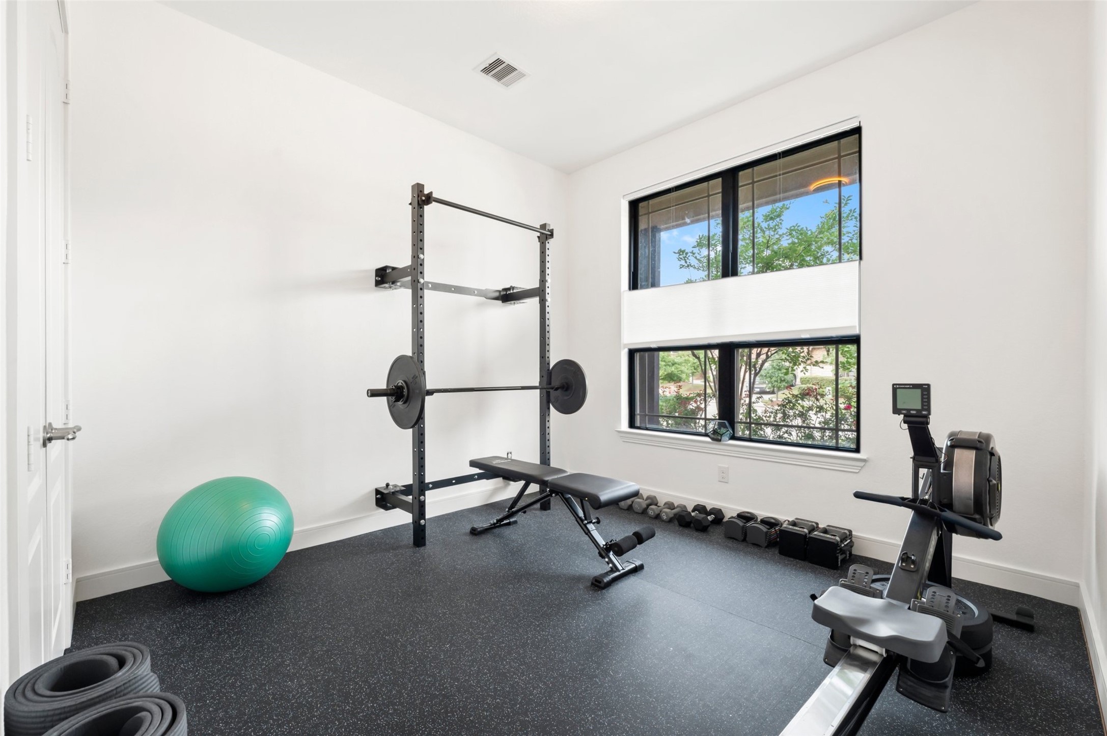 1053 Bat Hawk Court Conroe, TX 77385 - Photo 33 of 50 a room with gym equipment and a flat screen tv