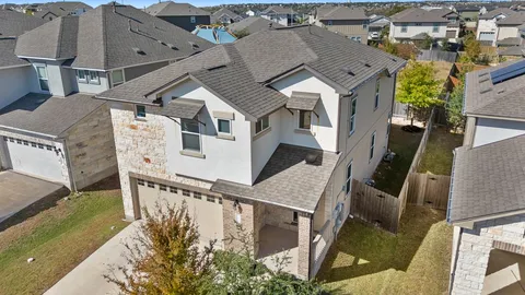 an aerial view of a house with wooden fence