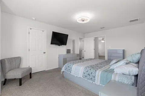 a bedroom with a bed and a flat screen tv