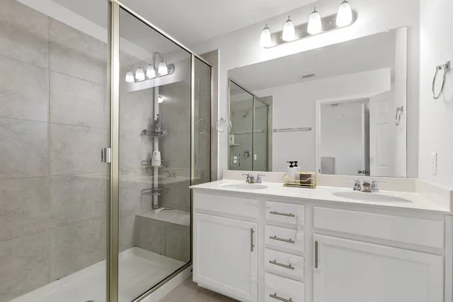 a bedroom with a bed a couch and a flat screen tv