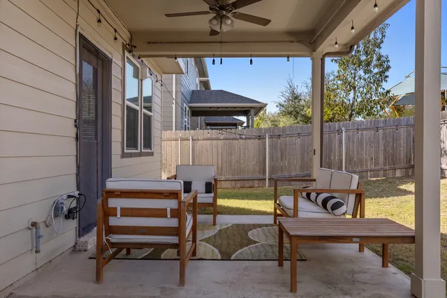 a view of a house with backyard porch and sitting area