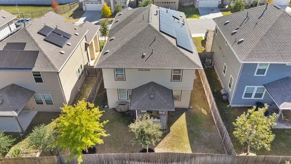 an aerial view of a house with a yard