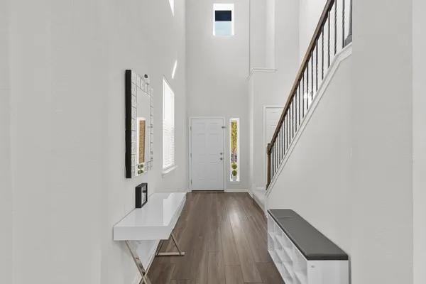 a view of an entryway with wooden floor