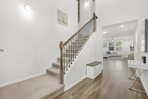 a view of entryway and hall with wooden floor
