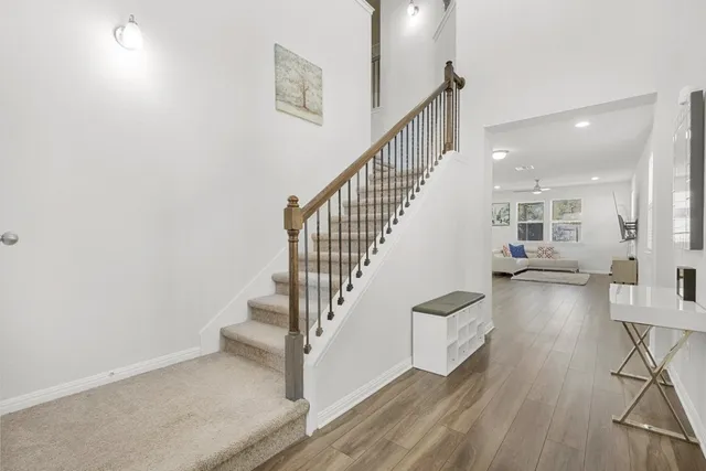 a view of entryway and hall with wooden floor