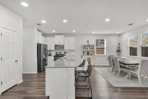 a view of a dining room with furniture and wooden floor