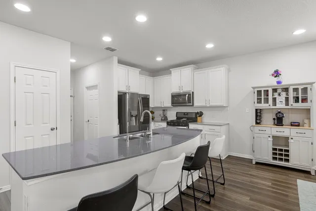 a kitchen with refrigerator and cabinets