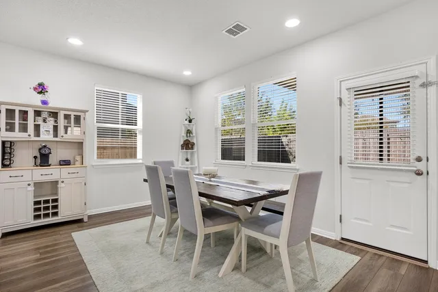 a dining room with furniture and window