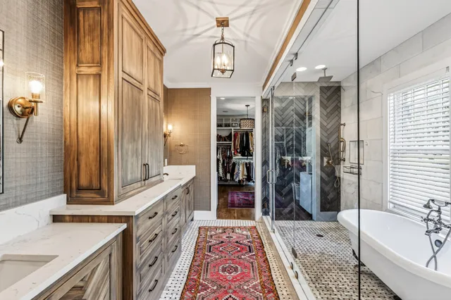 a bathroom with a double vanity sink a mirror and a shower