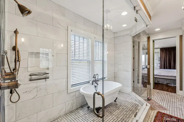 a bathroom with a bathtub and shower