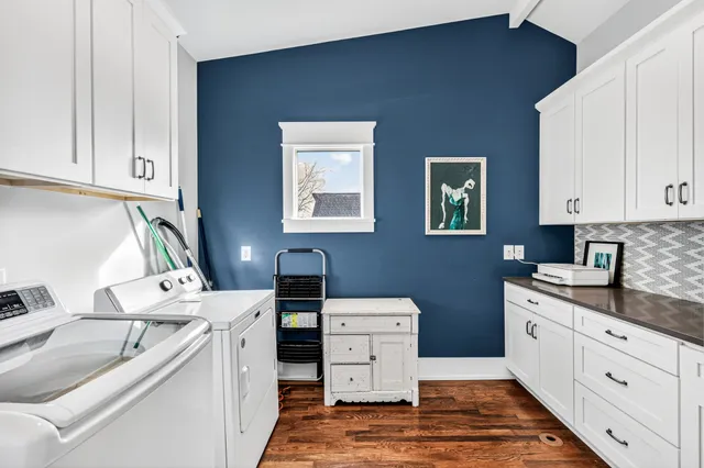 a kitchen with white cabinets and white appliances