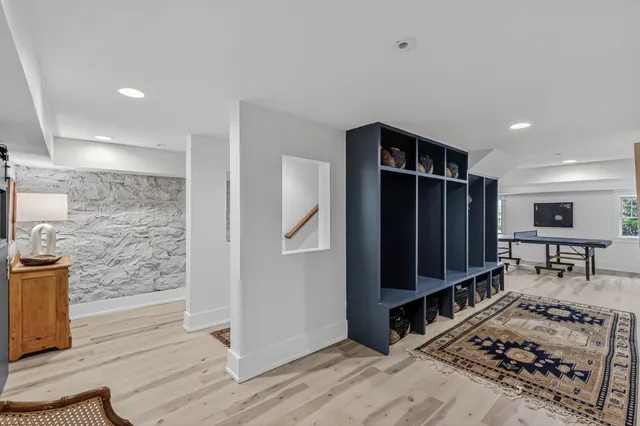 a view of room with wooden floor and furniture