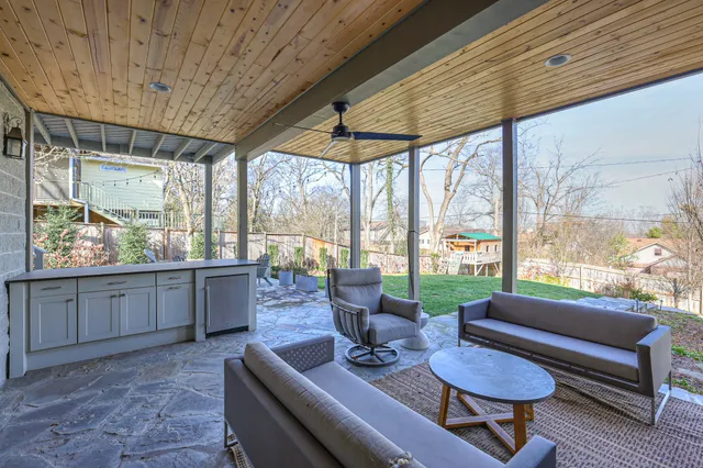a living room with furniture and a large window