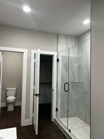a bathroom with a shower and a toilet