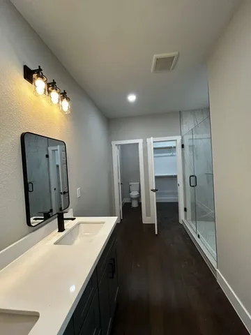 a bathroom with double vanity sink and a mirror