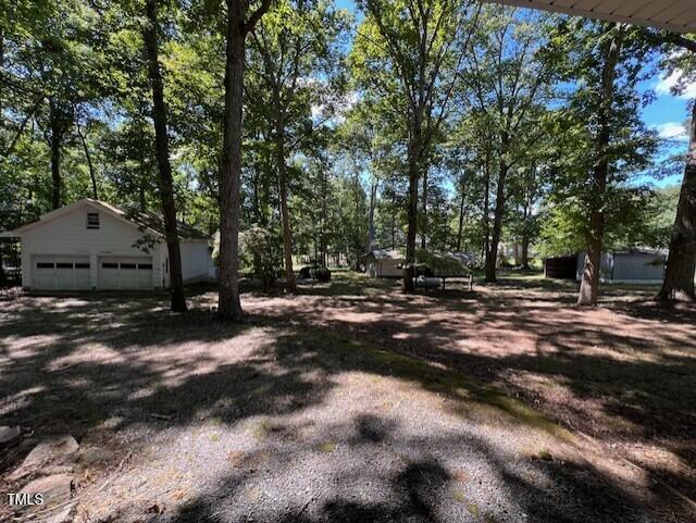 5629 Tabbs Creek Road Oxford, NC 27565 - Photo 11 of 40 a backyard of a house with trees