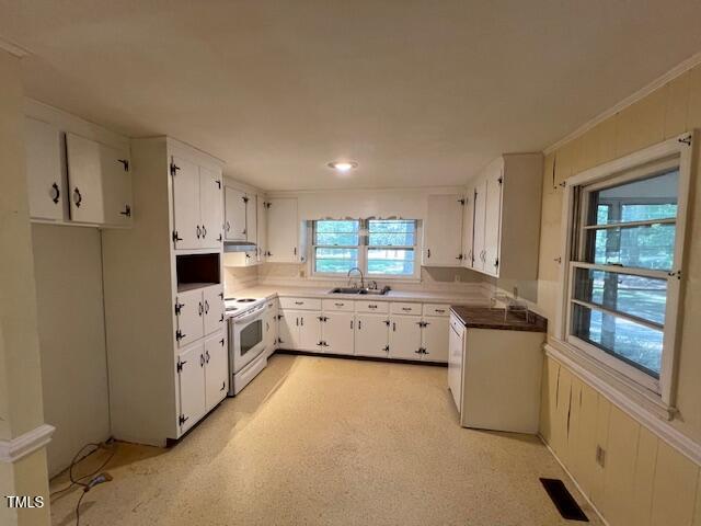 5629 Tabbs Creek Road Oxford, NC 27565 - Photo 22 of 40 a kitchen that has a lot of cabinets in it and wooden floors