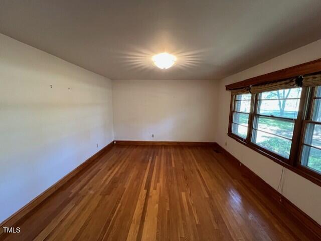 5629 Tabbs Creek Road Oxford, NC 27565 - Photo 24 of 40 wooden floor in an empty room with a window