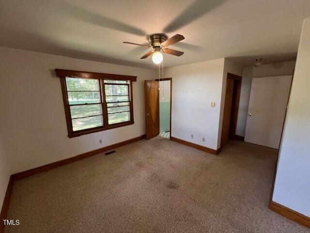 5629 Tabbs Creek Road Oxford, NC 27565 - Photo 30 of 40 an empty room with ceiling fan and window