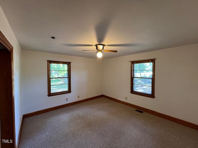 5629 Tabbs Creek Road Oxford, NC 27565 - Photo 32 of 40 an empty room with windows and closet