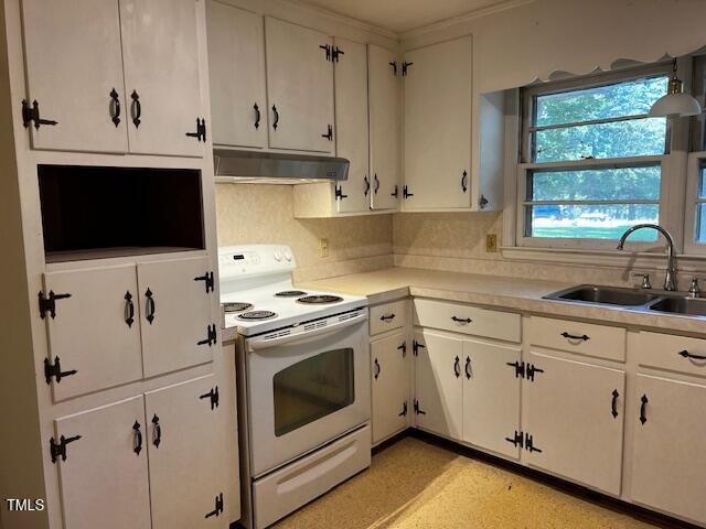 5629 Tabbs Creek Road Oxford, NC 27565 - Photo 36 of 40 a kitchen with granite countertop white cabinets and white appliances