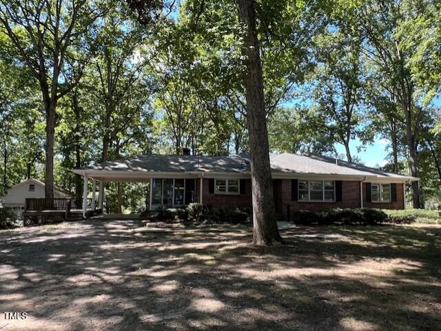5629 Tabbs Creek Road Oxford, NC 27565 - Photo 4 of 40 a view of a town with large trees and a barn
