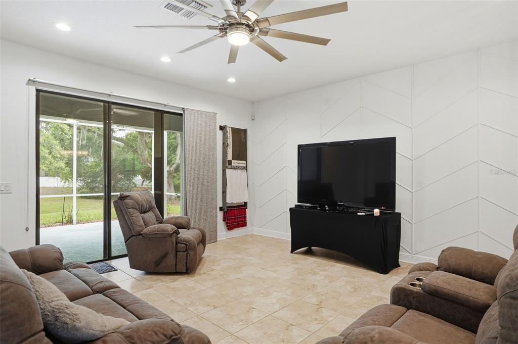 12417 Coralbean Court New Port Richey, FL 34654 - Photo 11 of 64 a living room with furniture and a flat screen tv