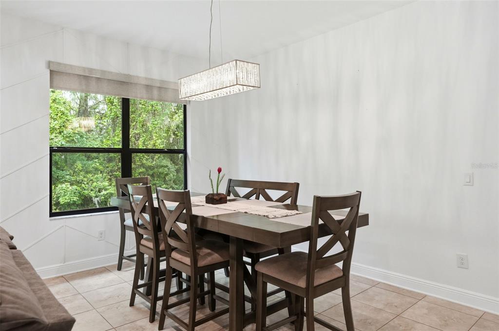 12417 Coralbean Court New Port Richey, FL 34654 - Photo 17 of 64 a view of a dining room with furniture window and outside view