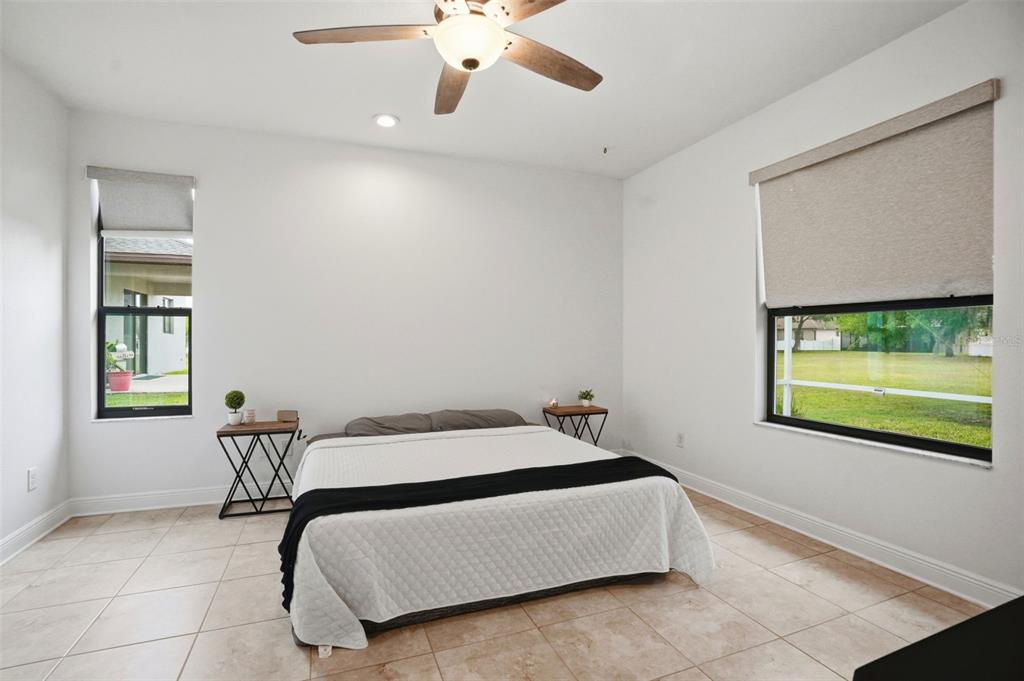 12417 Coralbean Court New Port Richey, FL 34654 - Photo 19 of 64 a bed room with a bed and a chair