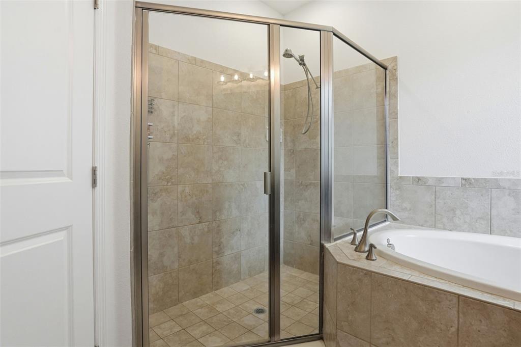 12417 Coralbean Court New Port Richey, FL 34654 - Photo 24 of 64 a bathroom with a bathtub and shower