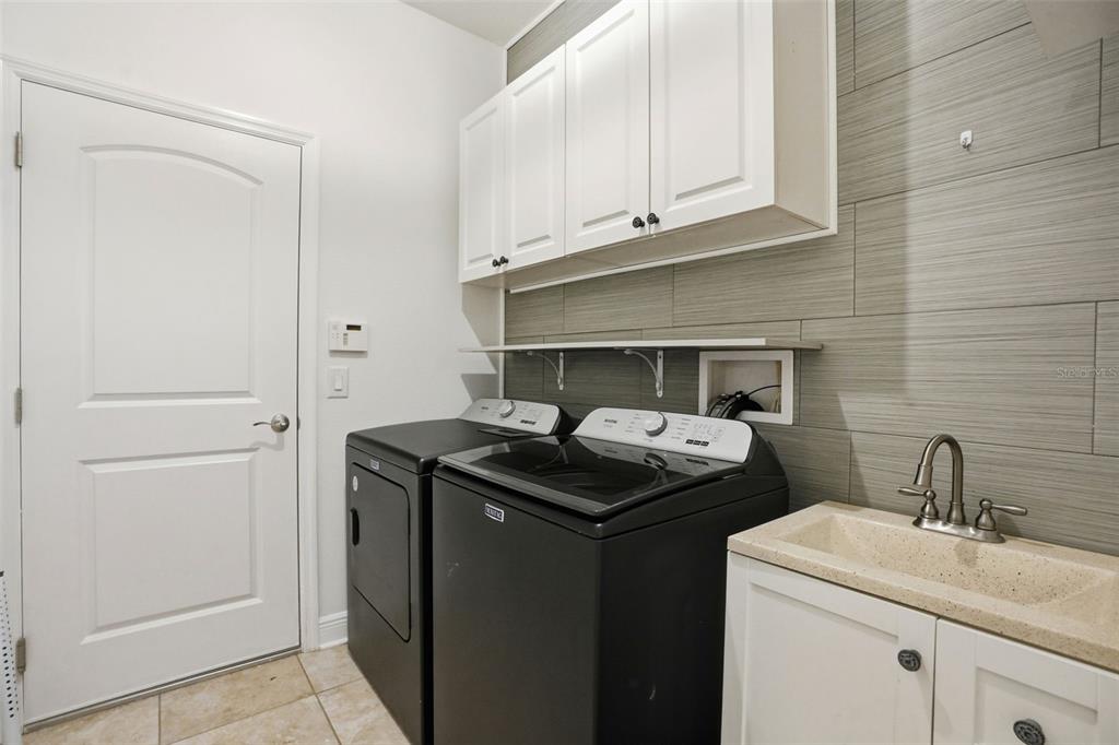 12417 Coralbean Court New Port Richey, FL 34654 - Photo 39 of 64 a utility room with sink dryer and washer