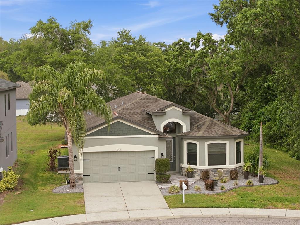 12417 Coralbean Court New Port Richey, FL 34654 - Photo 51 of 64 a front view of a house with garden