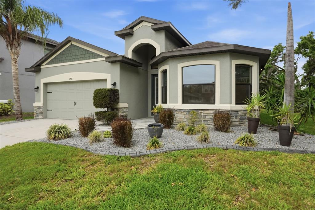 12417 Coralbean Court New Port Richey, FL 34654 - Photo 62 of 64 a front view of a house with garden