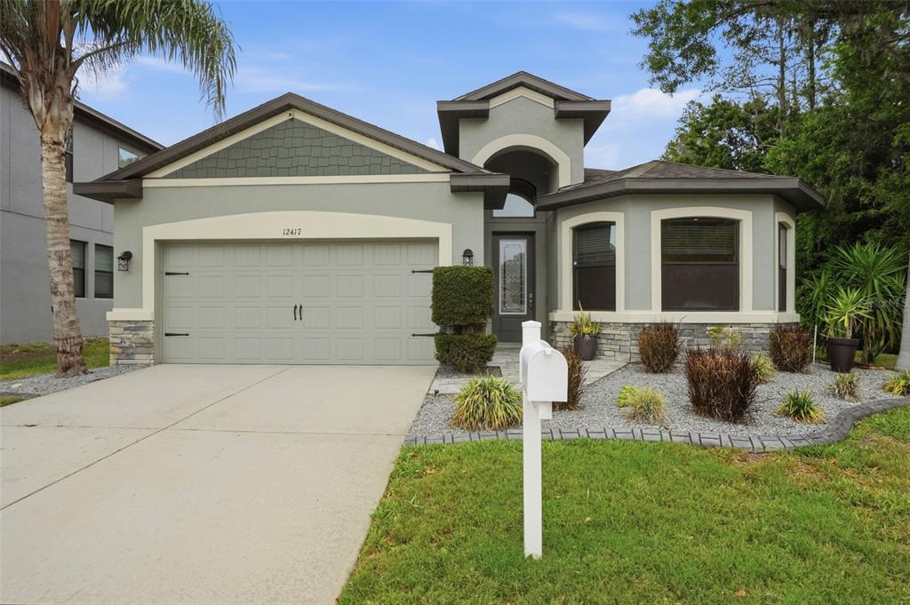 12417 Coralbean Court New Port Richey, FL 34654 - Photo 63 of 64 a front view of a house with a yard