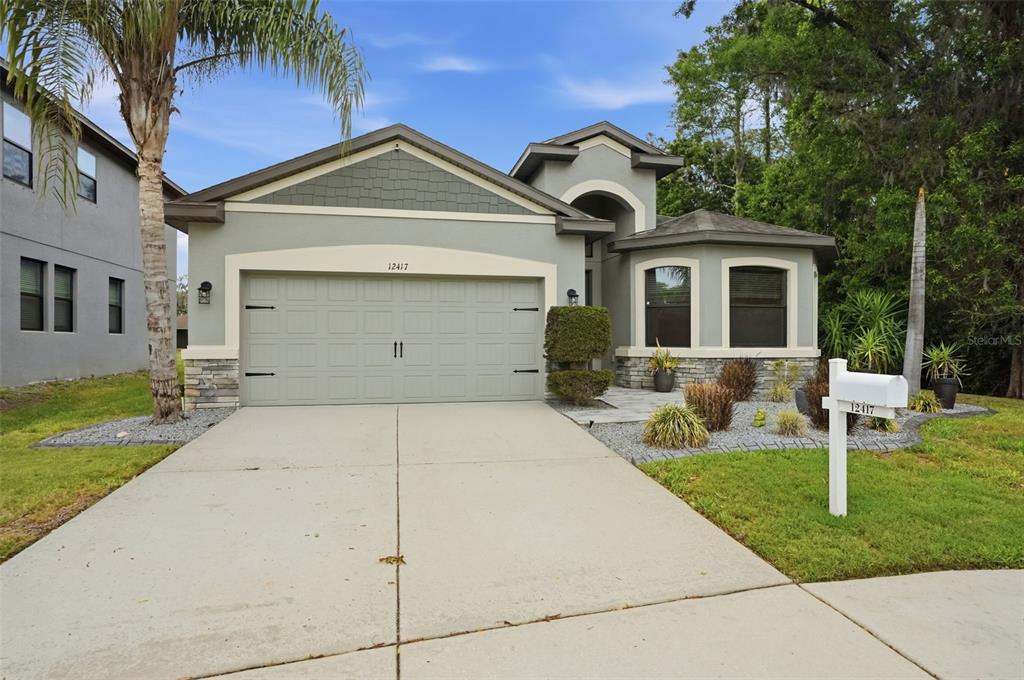 12417 Coralbean Court New Port Richey, FL 34654 - Photo 64 of 64 a front view of a house with garden
