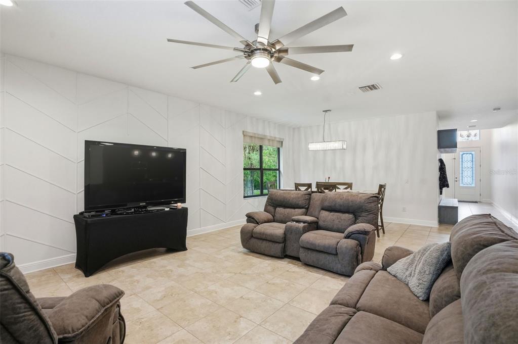 12417 Coralbean Court New Port Richey, FL 34654 - Photo 10 of 64 a living room with furniture and a flat screen tv