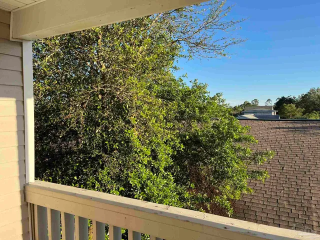 a view of a wooden fence and trees
