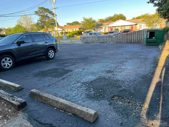a view of a backyard with a car parked