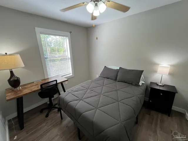 a bedroom with a bed and a window