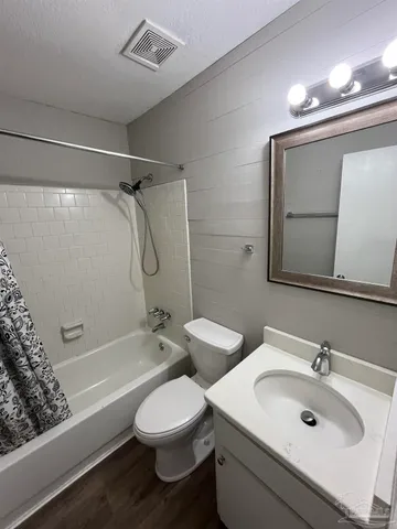 a bathroom with a double vanity sink toilet mirror and shower