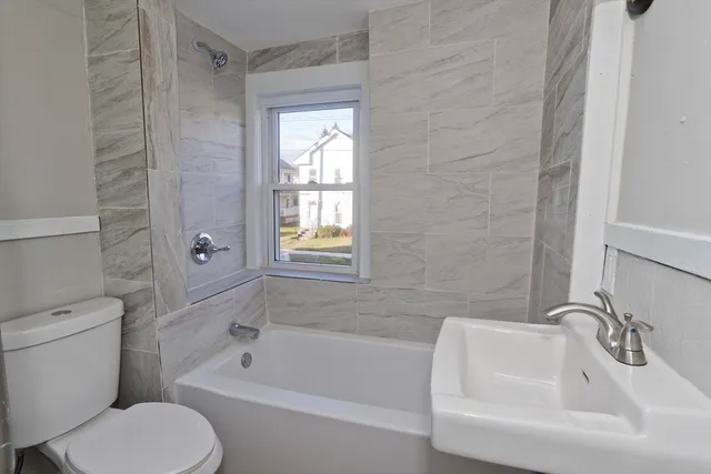 a bathroom with a toilet sink and bathtub