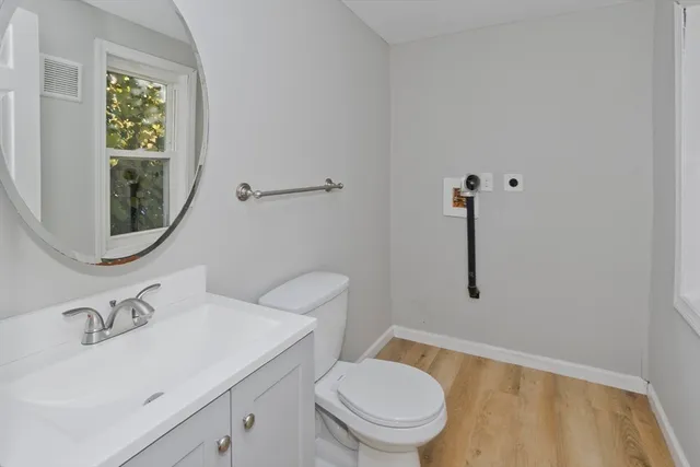 a bathroom with a sink a toilet and a mirror