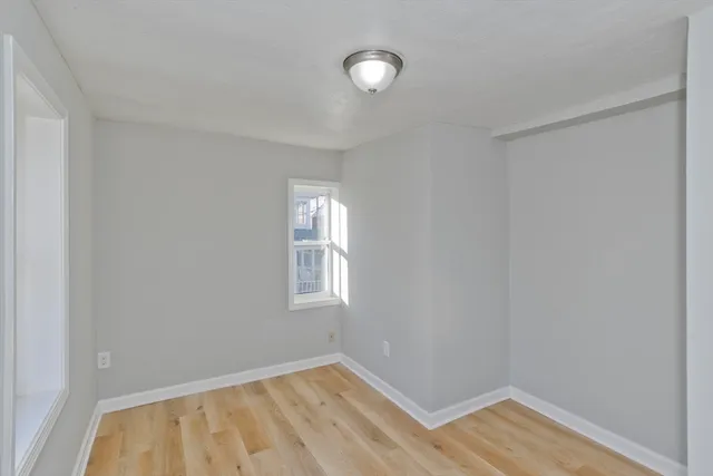 a view of room with window and hardwood floor